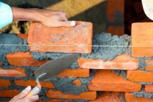 Professional brick wall construction showing expert brickwork and boundary wall building in London.